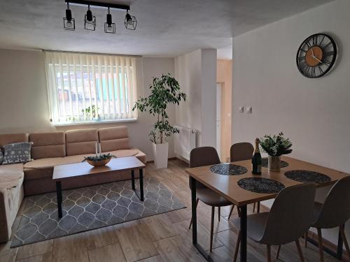 a living room with a couch and a table and chairs at Ubytovanie u Karasa in Vitanová