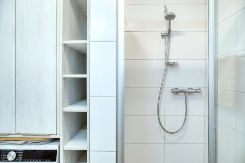 a shower with a shower head in a bathroom at Ferienwohnung Familiengarten in Volders