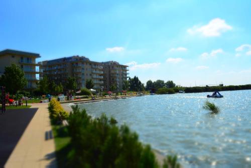 a body of water with a boat in it at Wellness Apartments in Velence in Velence
