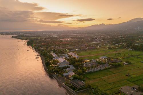 an aerial view of a town next to a body of water at The Lovina in Lovina
