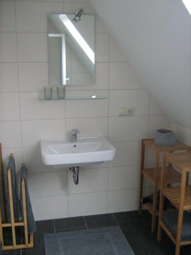 a bathroom with a sink and a mirror at Luettje-Glueck in Pogum