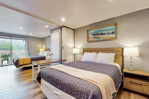a hotel room with two beds and a table at Sea Treasures Inn #211 in Rockaway Beach