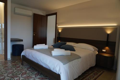 a bedroom with a large bed with two pillows at Mille Mt Suites - Cercemaggiore in Cercemaggiore