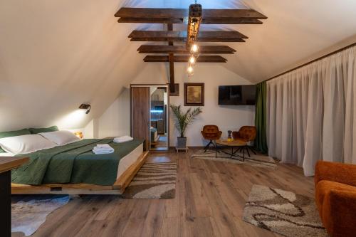 a bedroom with a bed and a ceiling with a chandelier at DIM Studio in Braşov
