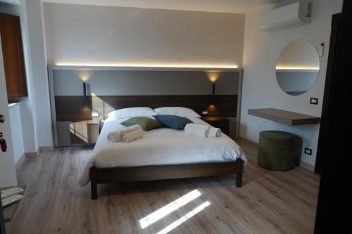 a bedroom with a large bed with white sheets and pillows at Mille Mt Suites - Cercemaggiore in Cercemaggiore
