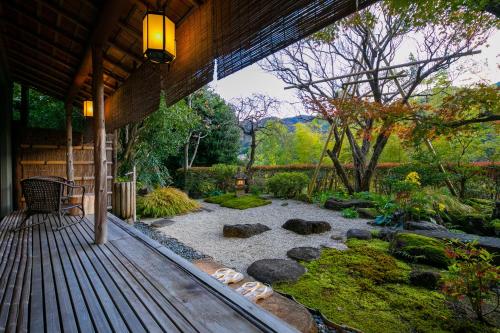 a patio with a garden with rocks and trees at Fukiya Ryokan in Yugawara
