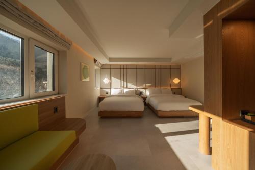 a bedroom with two beds and a couch at 신북 온심재 in Sajŏng-dong