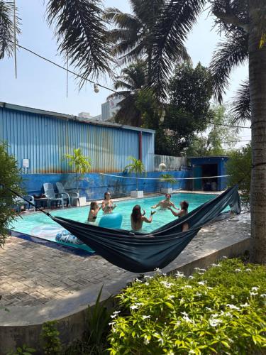 a group of people in a hammock in a swimming pool at Wake N Flow, Weligama in Weligama
