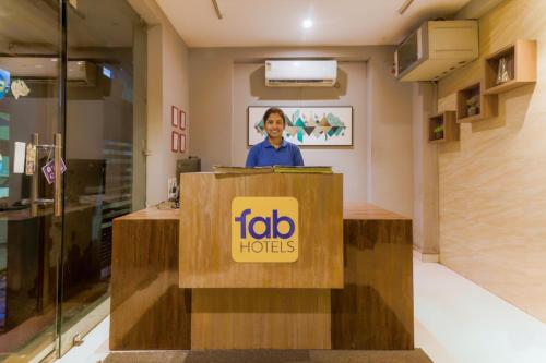 a man standing at a podium behind a lectern at FabHotel MB International in Kolkata