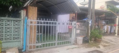 a gate in front of a building with plants at Blue Paradise Residence in Rawai Beach