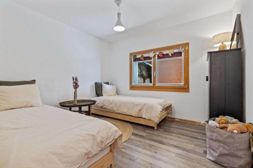 a bedroom with two beds and a window at Panoramic Alpine Garden Retreat in Vissoie