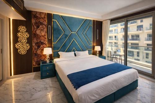 a bedroom with a large bed and a large window at Marjan Island Beautiful Apartment Sea Side View Beach Luxury Rooms Ras Al Khaimah UAE in Ras al Khaimah