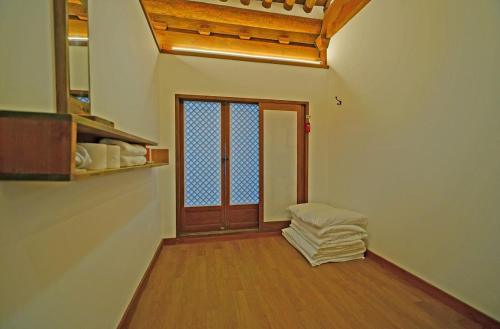 a room with a door and a wooden floor at Jeonju Hanok Agbae in Jeonju