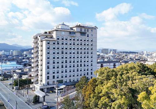 a tall white building with a city in the background at Hotel Castle Inn Ise in Ise