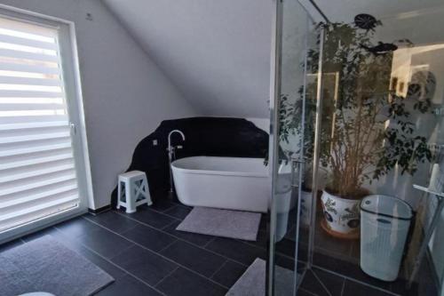 a bathroom with a shower and a bath tub at NEU! FeWo Maria Buch in Neresheim