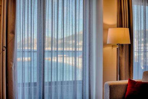 a room with a window with a view of the city at Kalamper Hotel & Spa in Dobra Voda