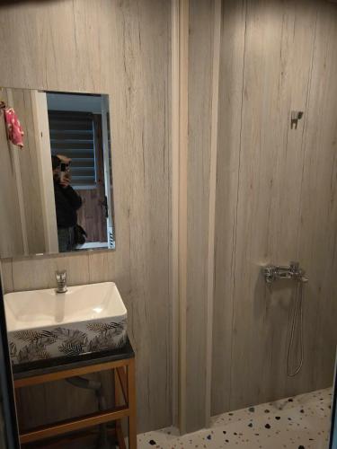 a bathroom with a white sink and a mirror at Ánh Dương House 2 in Da Thanh