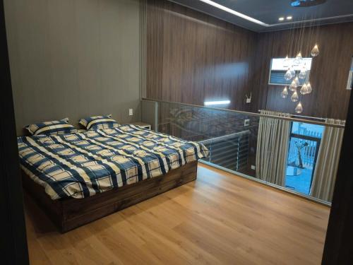 a bedroom with a bed in a room with a staircase at Ánh Dương House 2 in Da Thanh