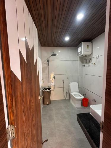 a bathroom with a toilet and a sink at Willow Winds Home Stay in Theog