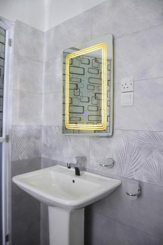a bathroom with a sink and a mirror on the wall at Ceylon Relax Villa in Aluthgama