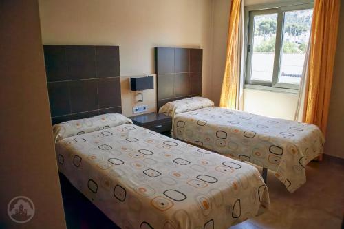 a hotel room with two beds and a window at Albir Palace in Albir