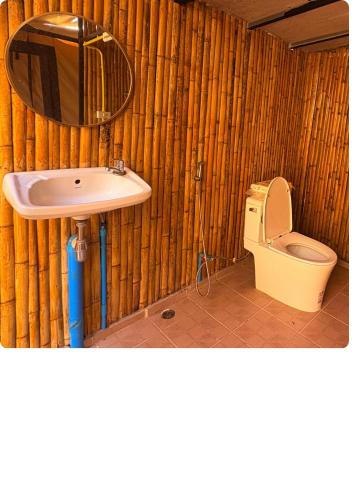 a bathroom with a sink and a toilet at Sireha Cafe Resort and Glamping in Ban Khok Chang