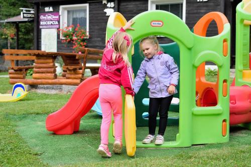 two young girls playing on a playground at Chaty Jasná in Demanovska Dolina