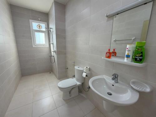 a bathroom with a toilet and a sink at Beautiful Salalah Beach Apartments - 1 by Beautiful Salalah Tours in Salalah