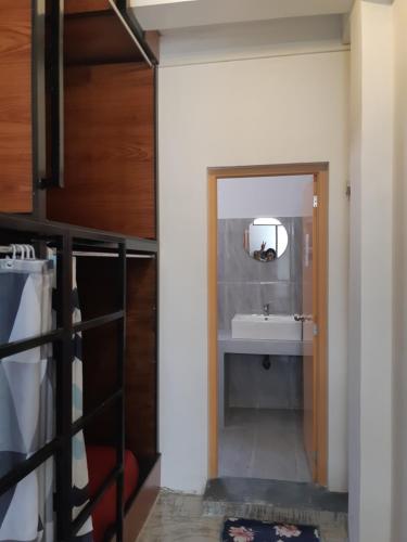 a bathroom with a sink and a mirror at Siril Guesthouse Hostel in Nuwara Eliya