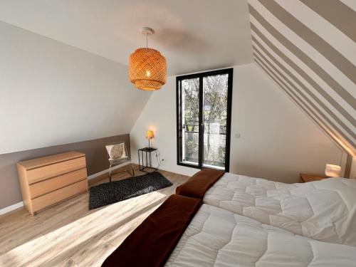 a bedroom with a large bed and a window at Gîtes du Point de Vue & du Causse d'Autoire in Autoire