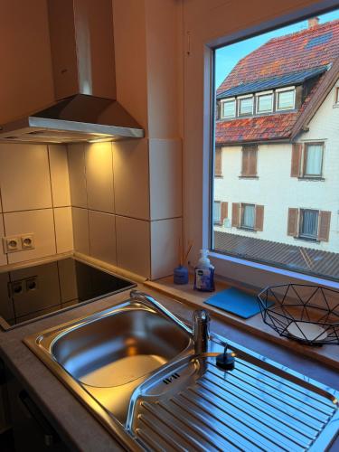 a kitchen with a sink and a window at Freudenstadt City Apartment in Freudenstadt