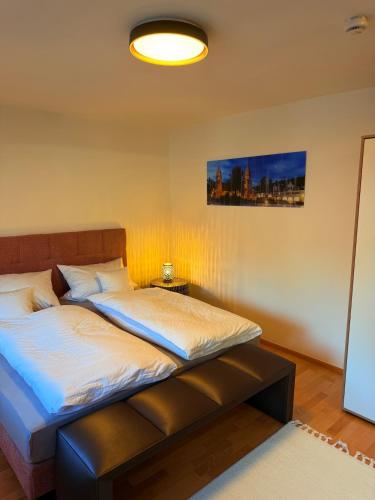 a bedroom with two beds and a lamp at Freudenstadt City Apartment in Freudenstadt