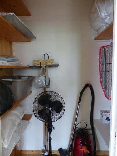 a kitchen with a fan on a wall at Gîte Les Hauts de Curemonte in Curemonte