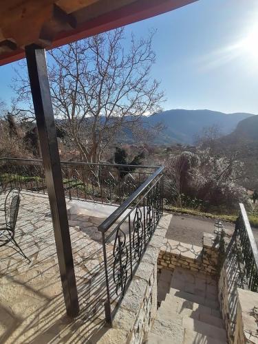 a balcony with stairs and a view of the mountains at Pera Vrisi in Zátouna