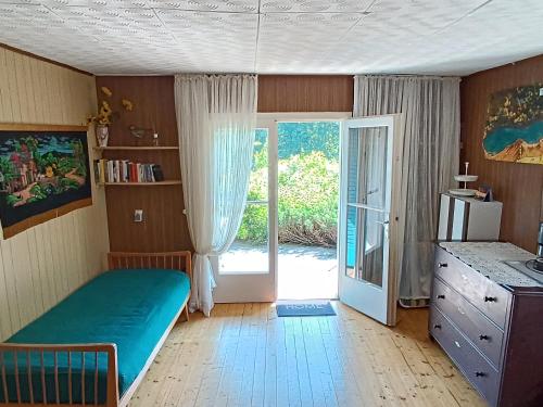 a room with a bed and a door to a patio at Ferienhaus Abhau-Tage in Ferlach
