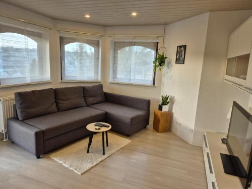 a living room with a couch and a table at Ferienwohnung Familie Aestel in Altensteig