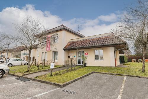 a house with a parking lot in front of it at Appart'City Classic Dijon - Toison D'Or in Ahuy