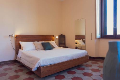 a bedroom with a large bed and a mirror at Villa Guardini - Lago di Como in Varenna