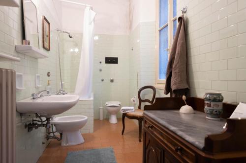 a bathroom with a sink and a toilet at Villa Guardini - Lago di Como in Varenna