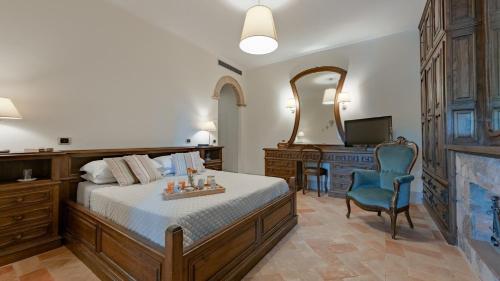 a bedroom with a bed and a desk and a television at Casa Andrea 12 in Orvieto