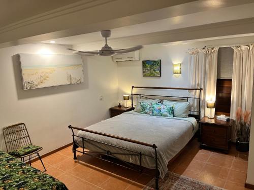 a bedroom with a bed and a chair in it at Oasis, in leafy Whitfield. in Edge Hill