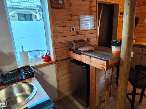 a kitchen in a tiny house with a counter at Vintage House in Augustów