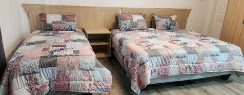two beds sitting next to each other in a bedroom at Riverside Inn in Oranjeville