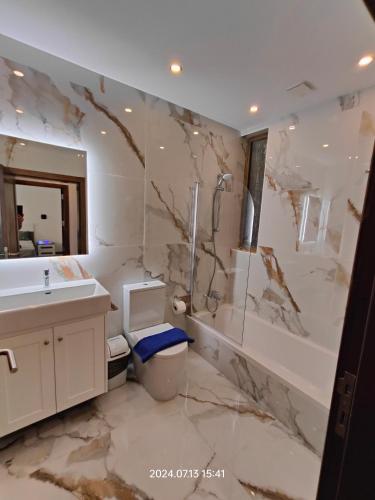 a bathroom with a sink toilet and a mirror at Seafront 3 bed Panoramic SeaViews Apt B7- in Qbajjar