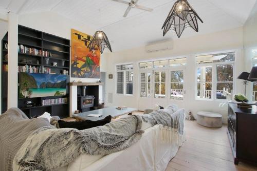 a living room with a white couch and a table at Malakoff House - Charm & Luxury in Beechworth