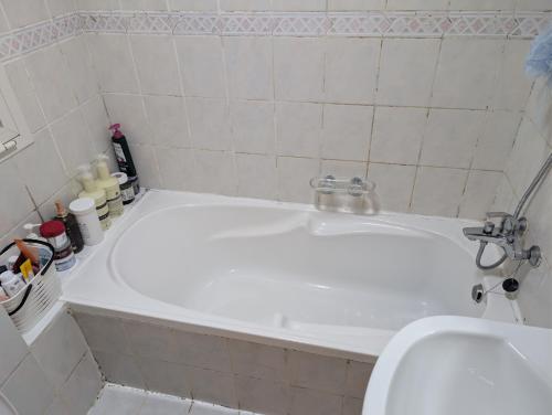 a bathroom with a sink and a bath tub at Elegant Double Room in Abu Dhabi
