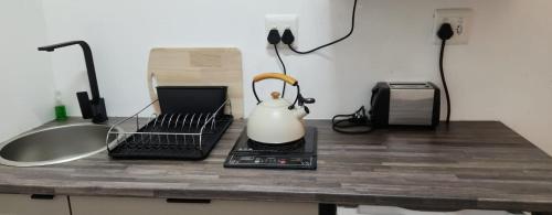 a kitchen counter with a tea kettle on top of it at Riverside Inn in Oranjeville