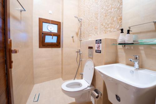 a bathroom with a toilet and a sink at Bait mutirah guesthouse in Muscat