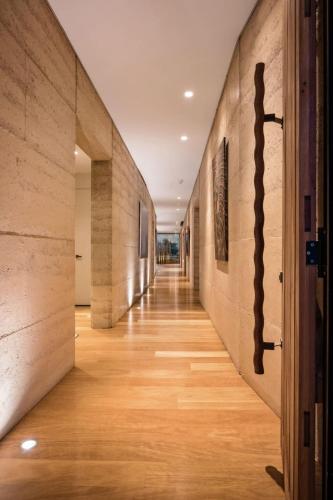 an empty hallway with wood floors and walls at The Meldrum in Beechworth