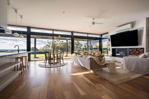 a living room with a couch and a table with chairs at The Meldrum in Beechworth